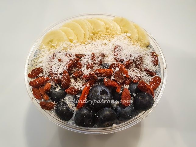  acai and topped with goji berries, blueberries, coconut flakes and banana