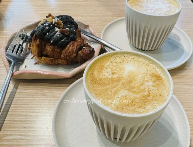 black sesame croissant and cappuccino